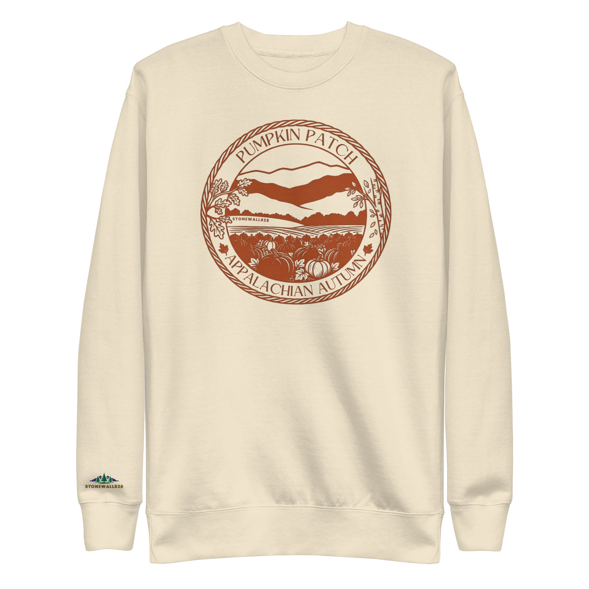 An off-white crewneck sweatshirt featuring a circular brown graphic on the chest that reads 'Pumpkin Patch Nепalagachan Autumn' with a stylized landscape and pumpkins, and a small green and blue logo on the left sleeve.