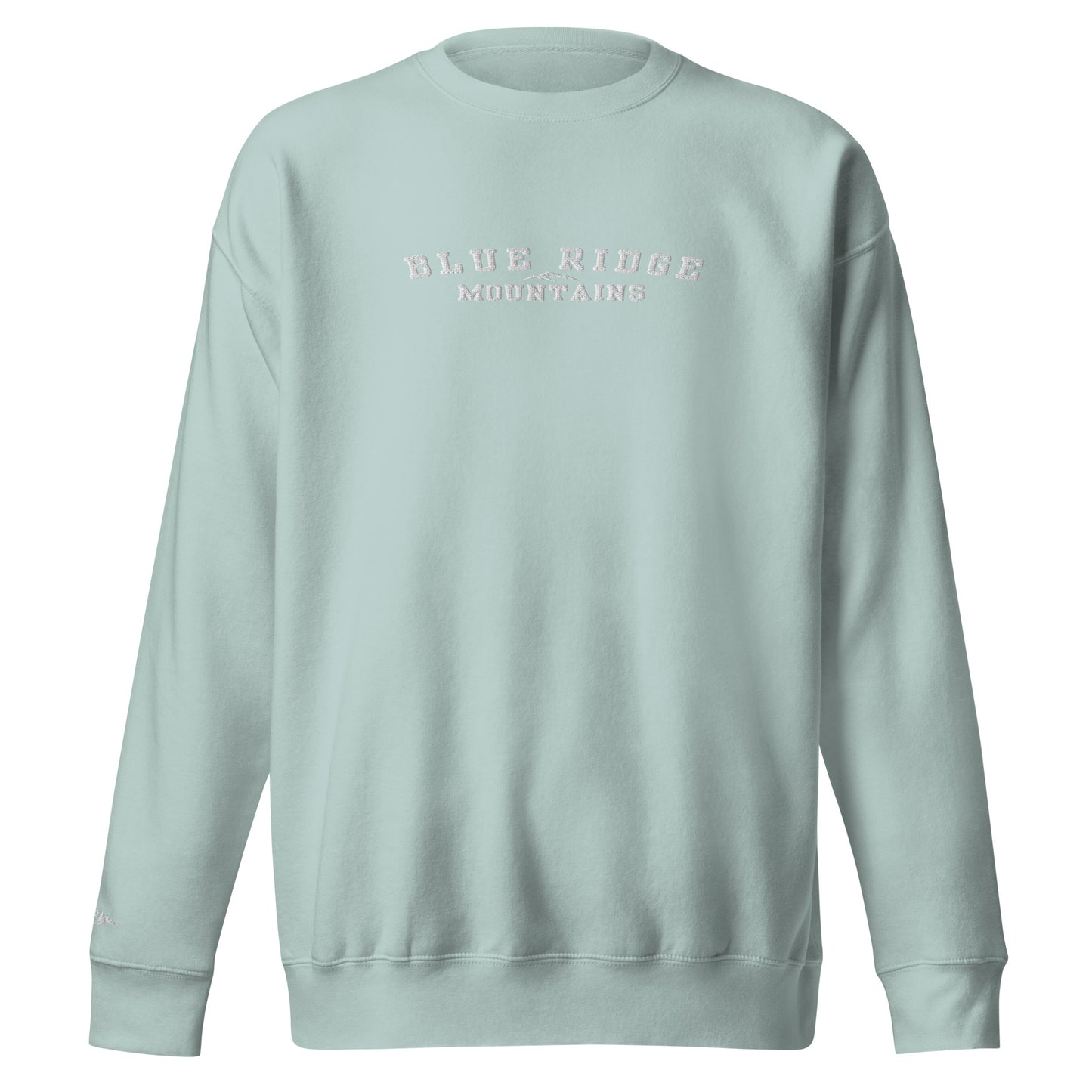 Product mockup. Featuring the bold text "Blue Ridge Mountains" paired with a simple, elegant graphic of the iconic rolling ridgelines, this pullover is a straightforward tribute to the ancient peaks and deep valleys that define Appalachian heritage. It’s an effortless, everyday piece made for anyone who holds a piece of these mountains in their heart.
