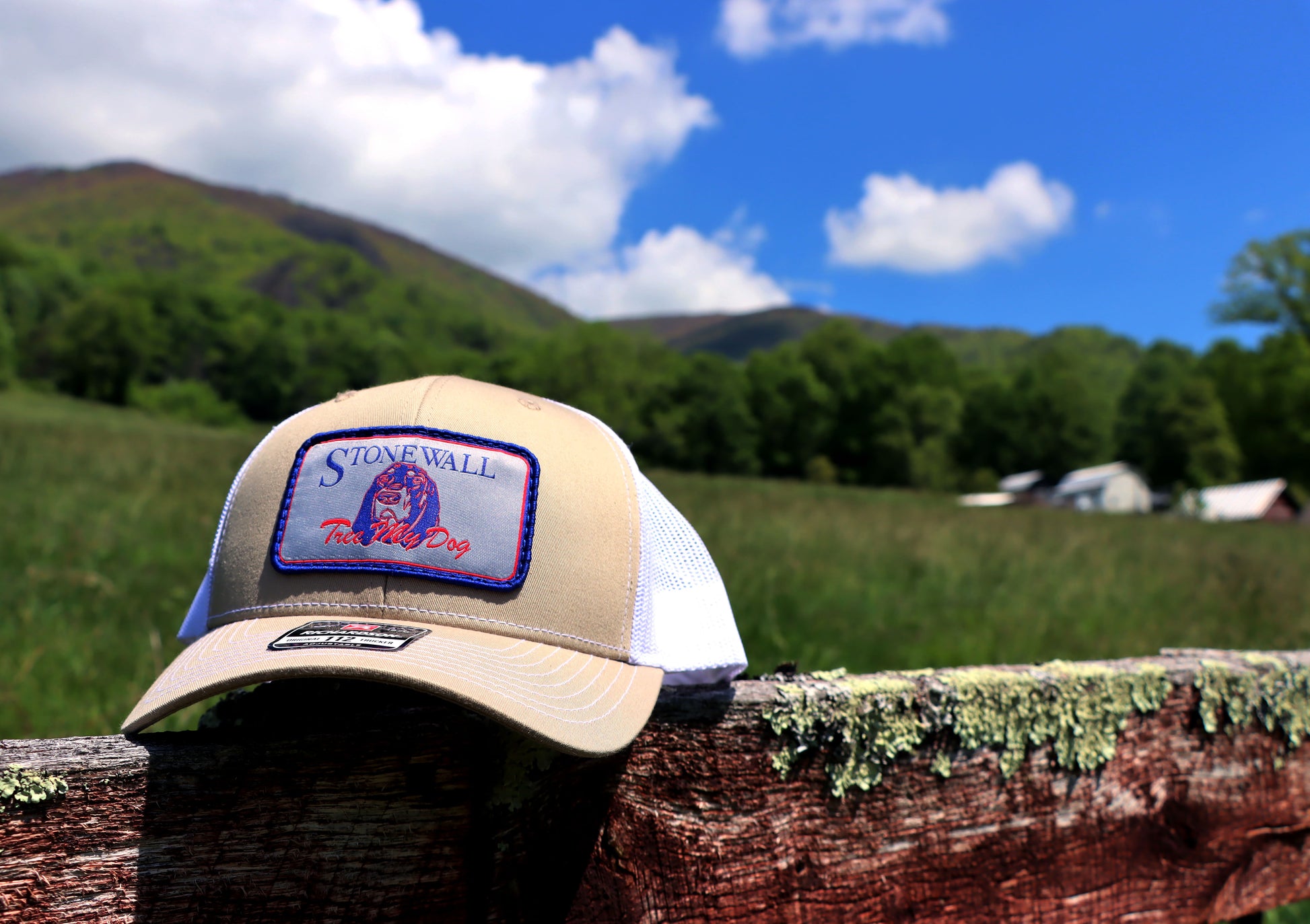 Khaki and white trucker hat with Stonewall logo patch
