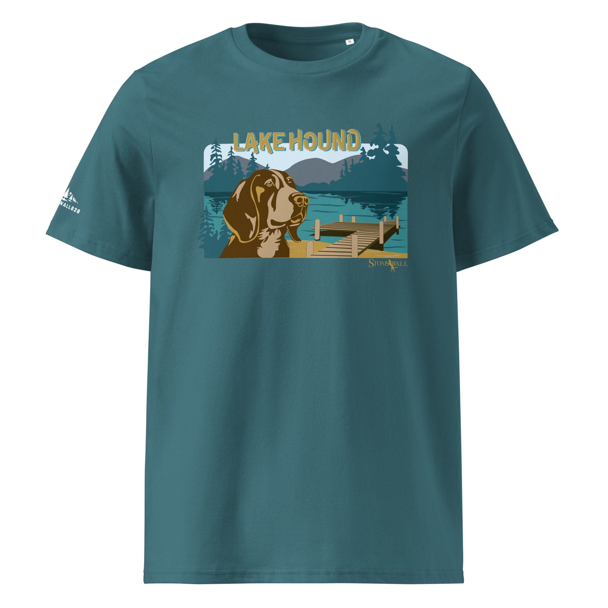 Product mockup, The Lake Hound Tee captures the perfect, slow-paced afternoon on the water. Featuring a relaxed hound taking in the view, this design is framed by a serene mountain lake, a wooden boat dock, dense woods, and the rolling blue ridges in the distance.