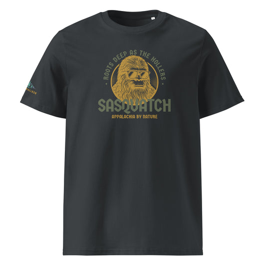 Product mockup, Featuring a cool, sunglass-wearing Sasquatch and the text "Appalachia by Nature," the Roots Deep as the Hollers Tee is a playful nod to the mysteries, the humor, and the untamed spirit of the Blue Ridge. Because being "Appalachia by nature" means having deep roots, a wild heart, and a laid-back attitude.