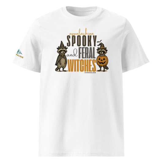 A white short-sleeve crewneck t-shirt featuring a Halloween graphic on the front with raccoon and cat illustrations wearing witch hats, alongside the text 'Appalachian Spooky and Feral Witches' and 'Stonewall828'. A small Stonewall828 logo is also visible on the left sleeve.