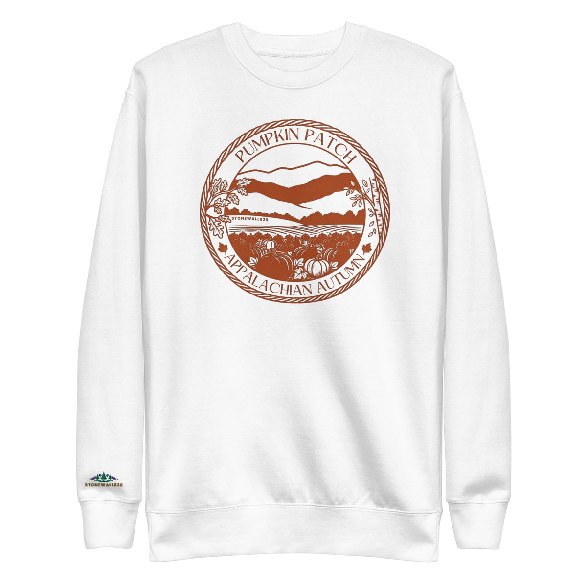 A white crewneck sweatshirt featuring a circular orange graphic on the chest that reads 'Pumpkin Patch Appalachian Autumn' with an illustration of a farm scene. A small green and white logo is printed on the left sleeve cuff.